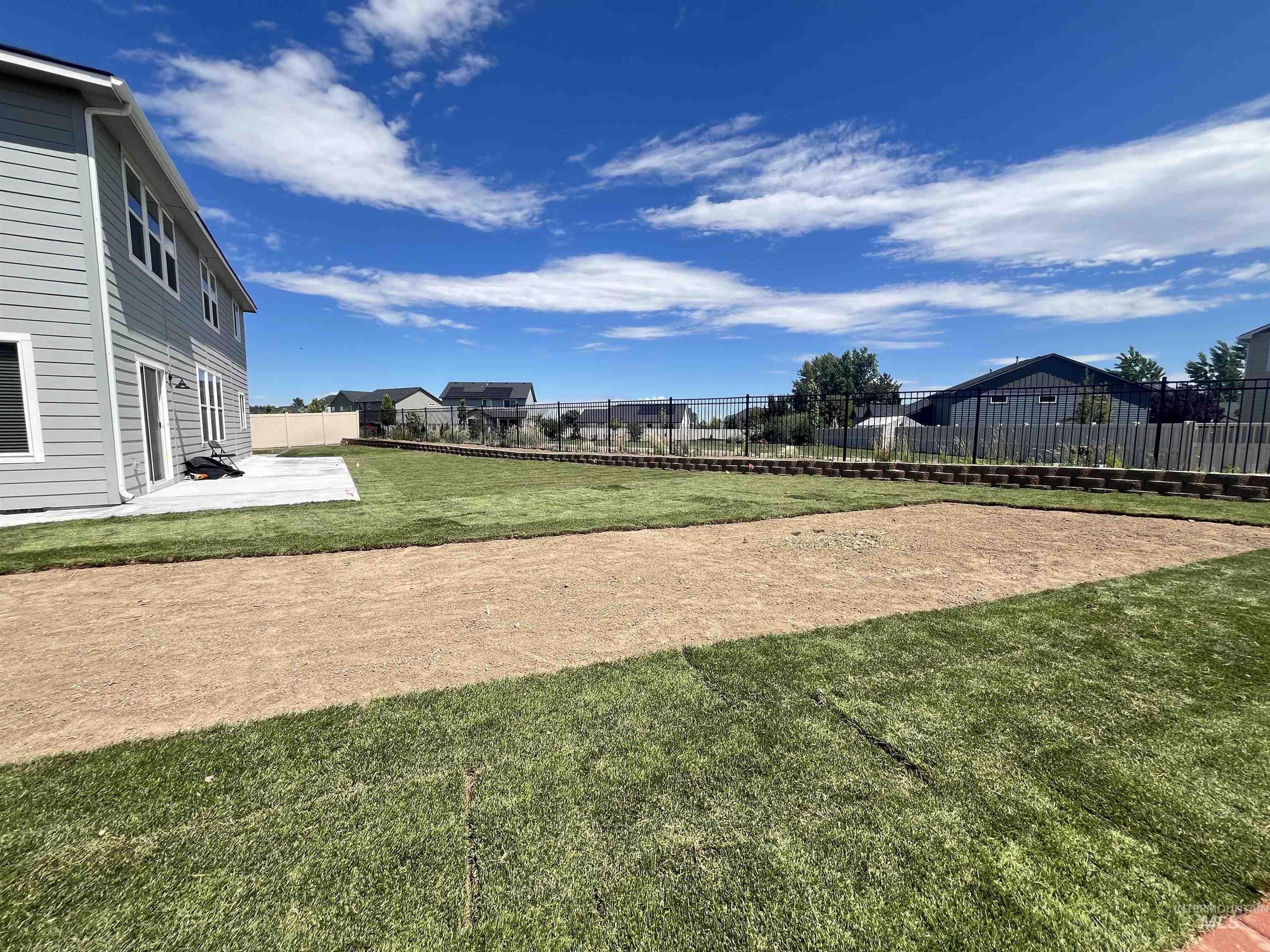 3508 South Edge Rim Way Meridian, ID 83642 - Photo 28 of 28 Expansive backyard featuring a new sod lawn and a dedicated area prepared for additional landscaping