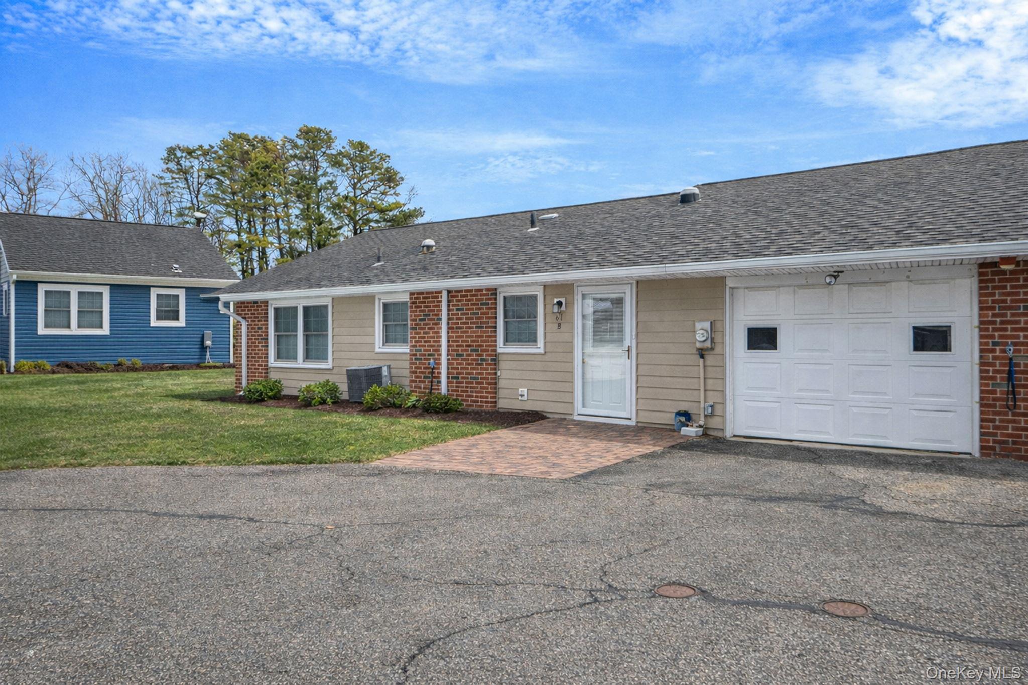61 Enfield Court, Unit B Ridge, NY 11961 - Photo 1 of 32 front view of house with a yard