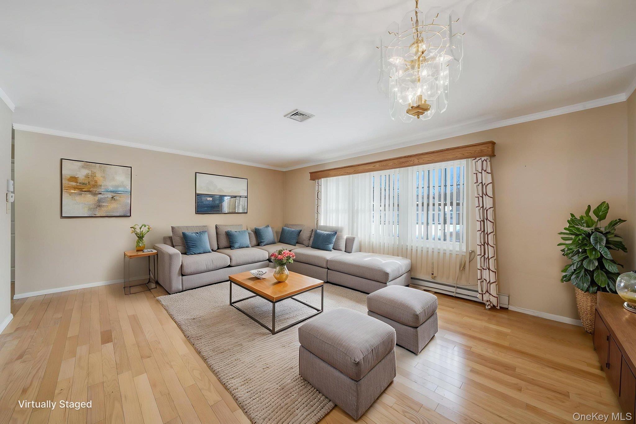 61 Enfield Court, Unit B Ridge, NY 11961 - Photo 14 of 32 a living room with furniture or chandelier and a wooden floor