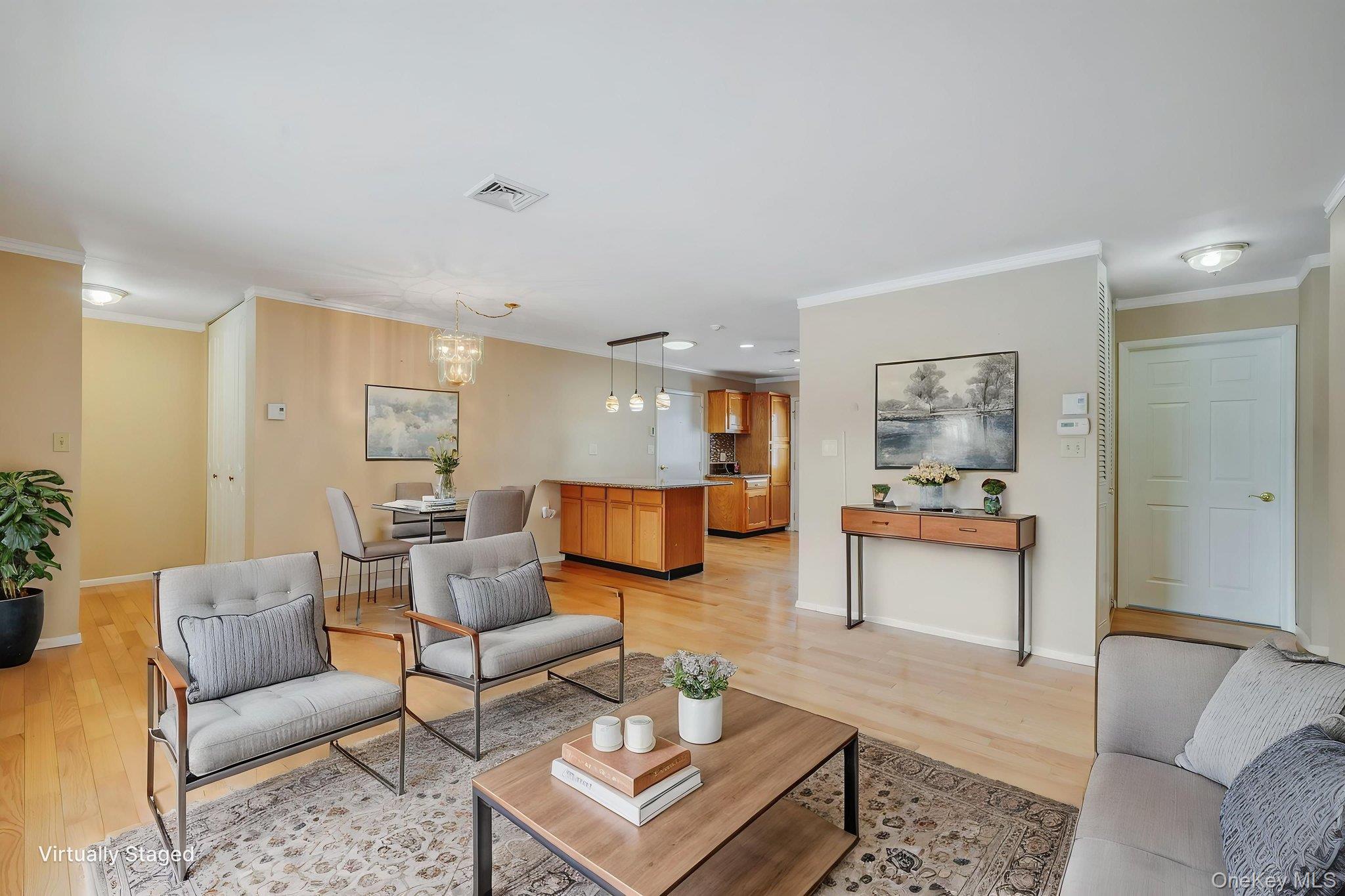 61 Enfield Court, Unit B Ridge, NY 11961 - Photo 16 of 32 a living room with furniture and wooden floor