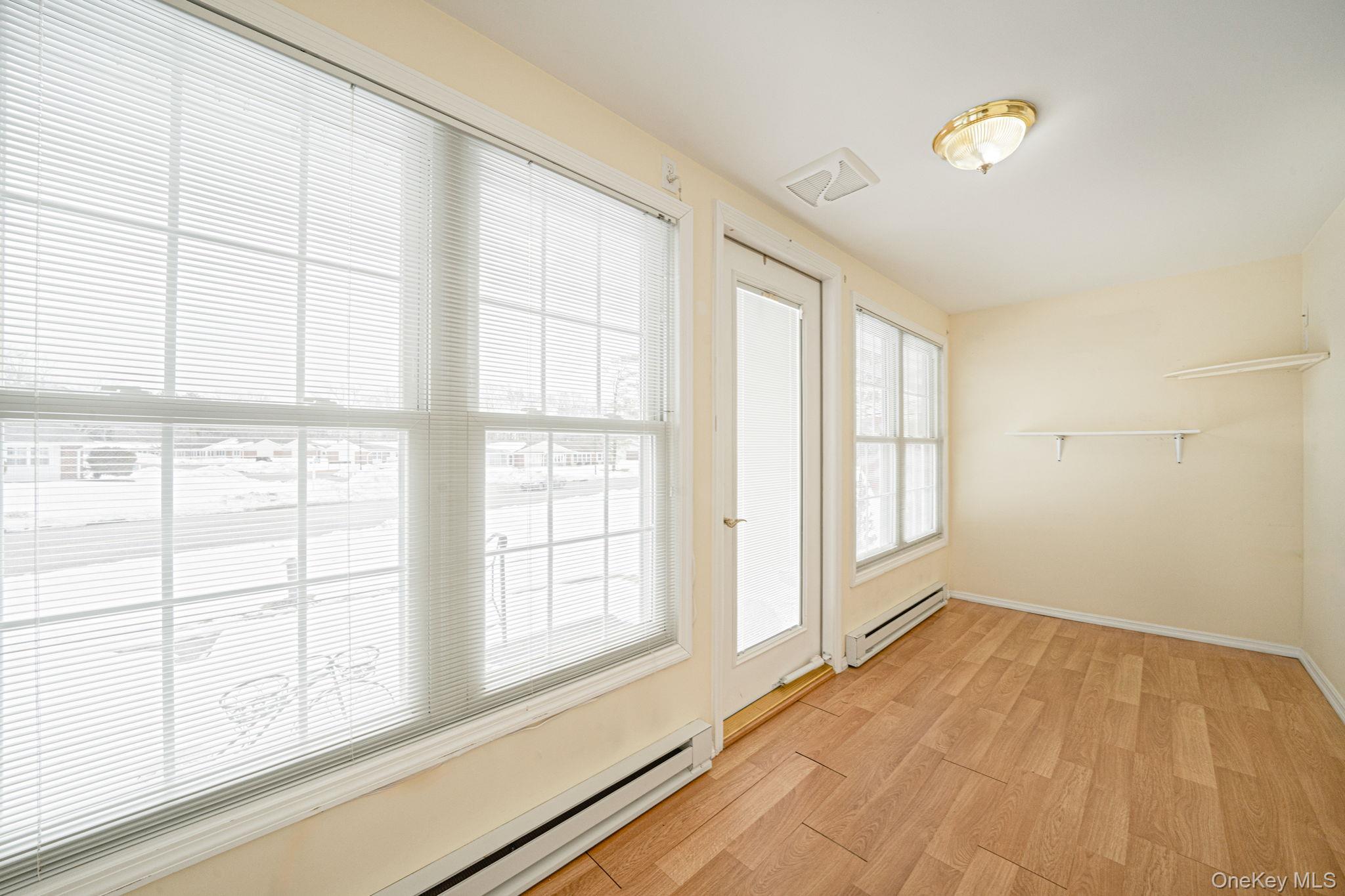 61 Enfield Court, Unit B Ridge, NY 11961 - Photo 19 of 32 an empty room with windows