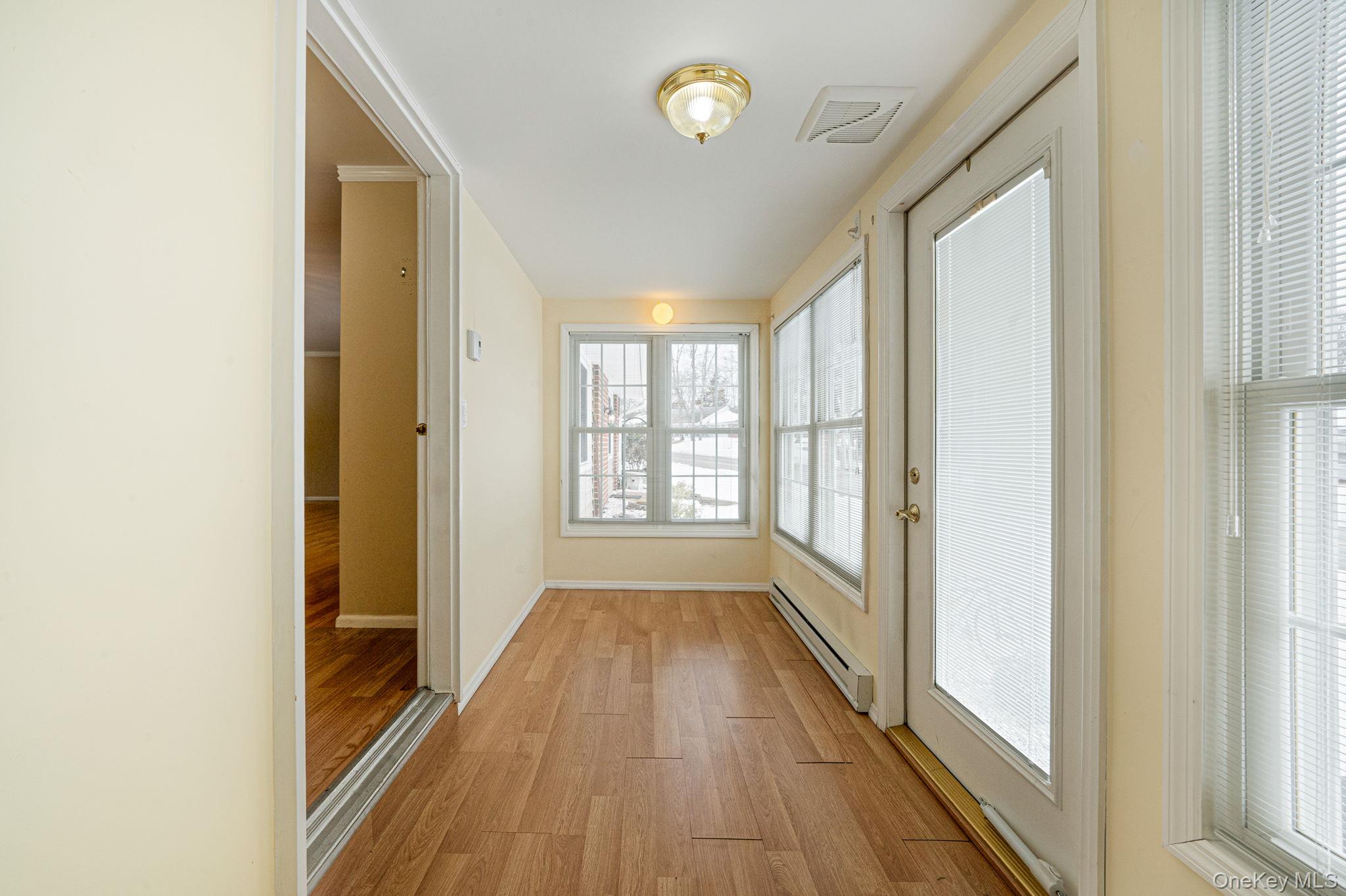 61 Enfield Court, Unit B Ridge, NY 11961 - Photo 20 of 32 a view of hallway with wooden floor and fan