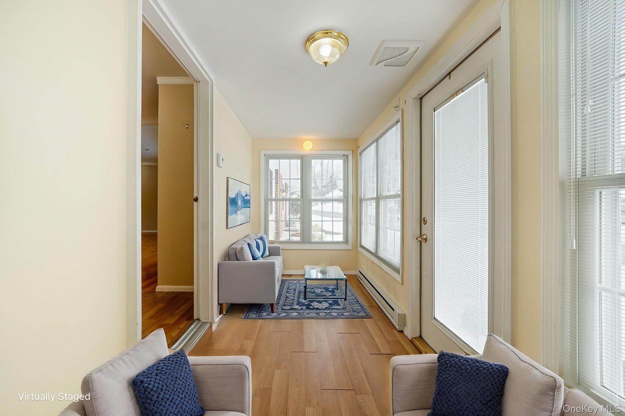 61 Enfield Court, Unit B Ridge, NY 11961 - Photo 21 of 32 a living room with furniture and a window