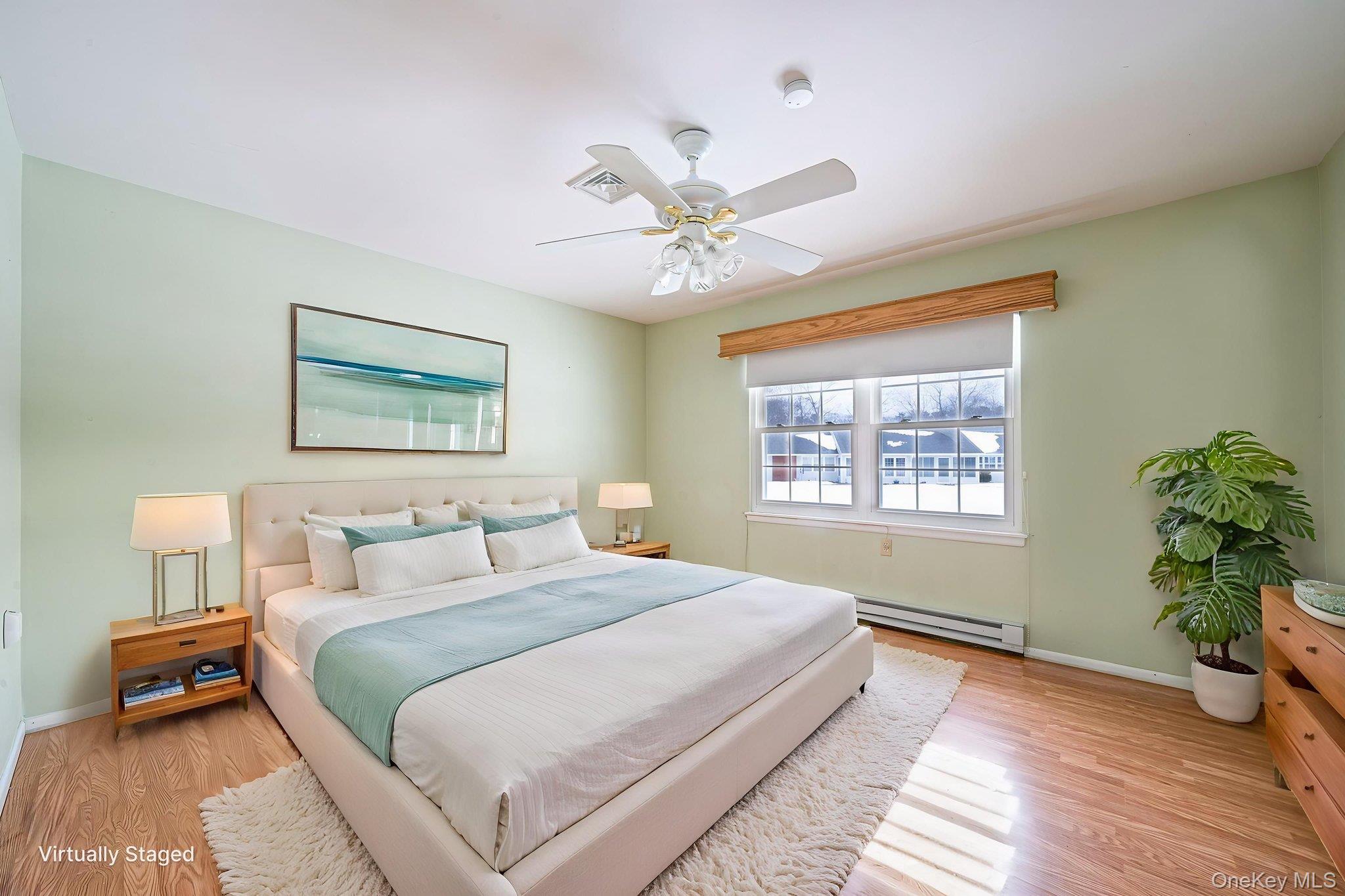 61 Enfield Court, Unit B Ridge, NY 11961 - Photo 23 of 32 a bedroom with a large bed and a window