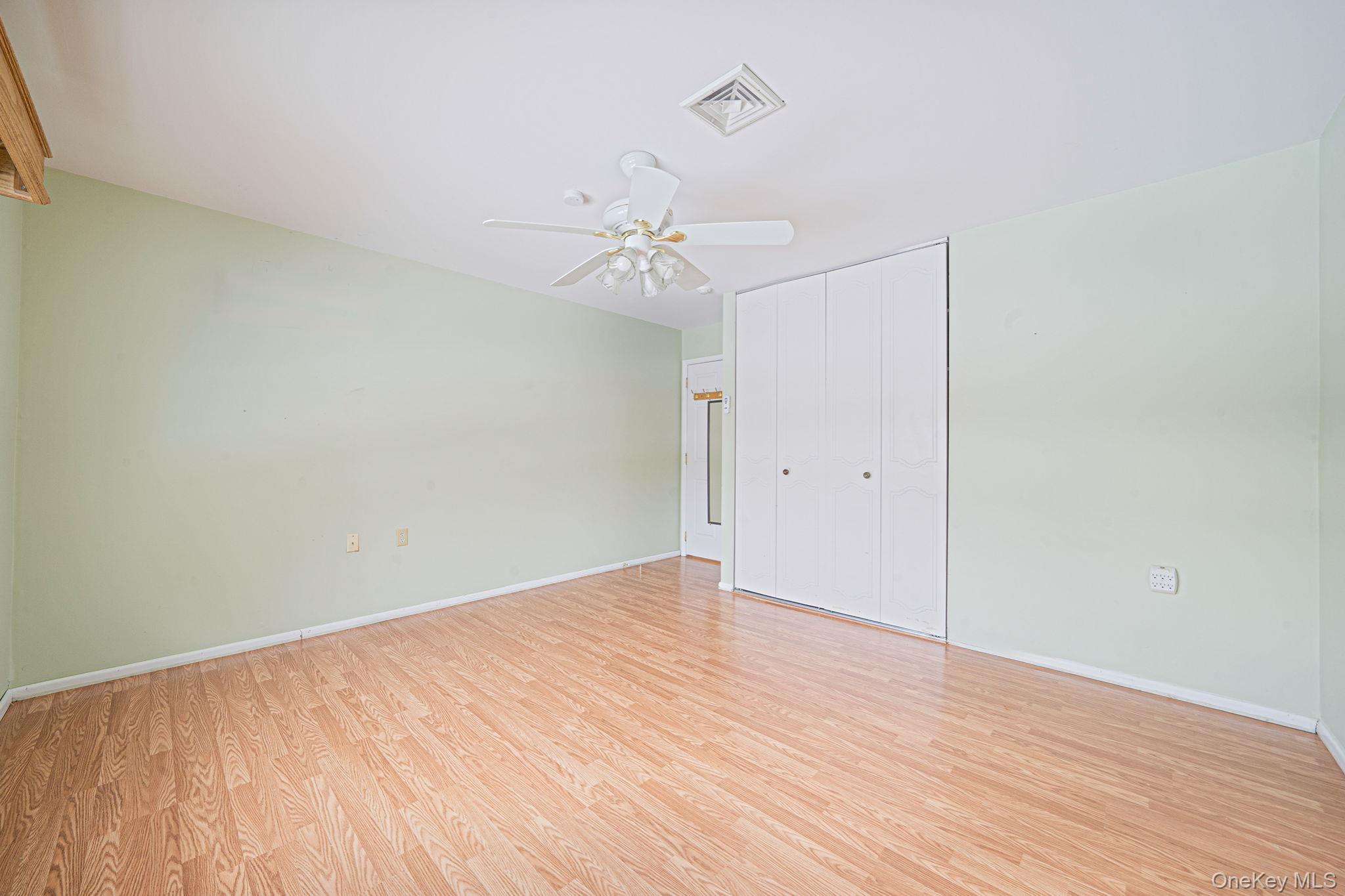 61 Enfield Court, Unit B Ridge, NY 11961 - Photo 24 of 32 wooden floor in an empty room