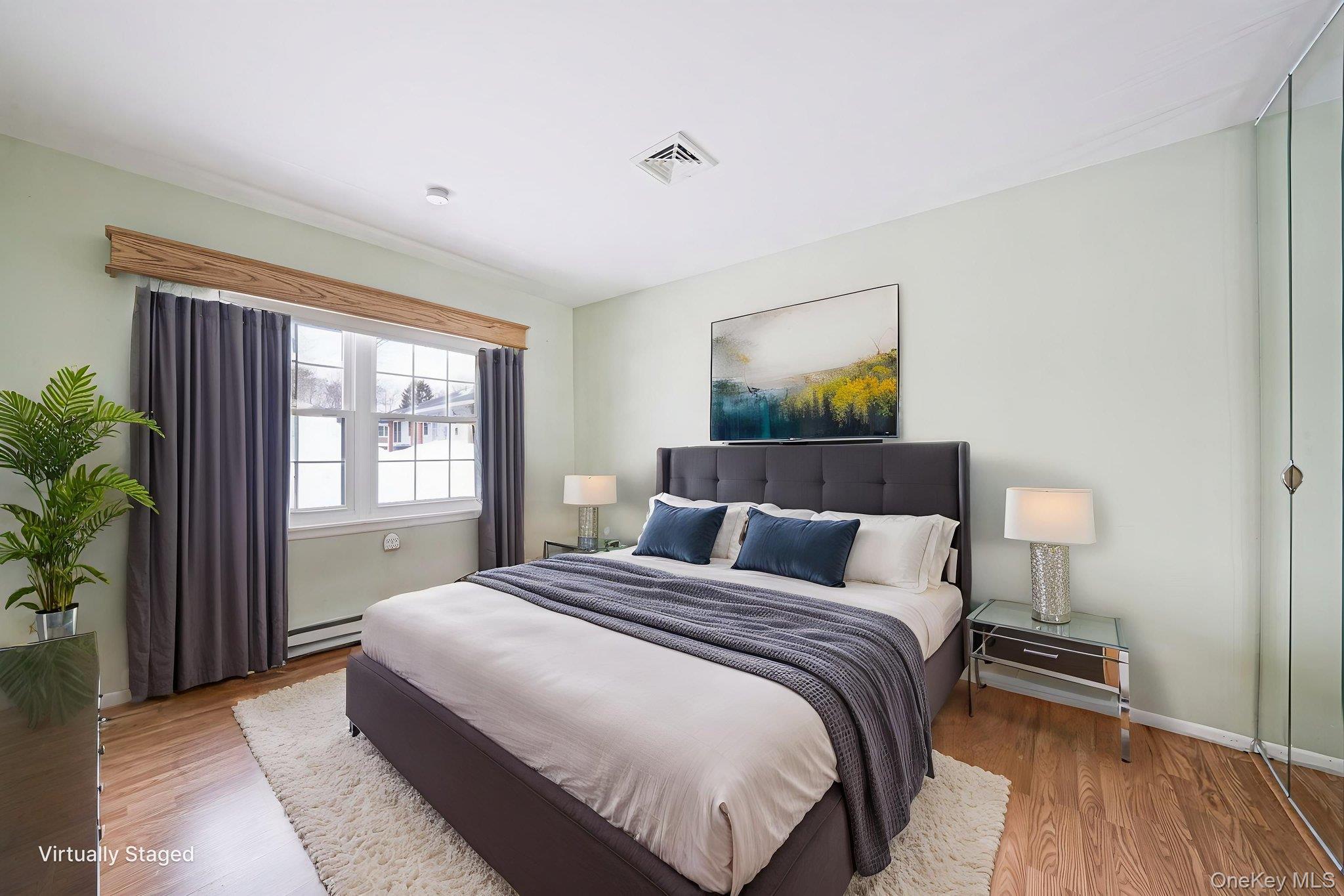 61 Enfield Court, Unit B Ridge, NY 11961 - Photo 26 of 32 a bedroom with a bed and a window