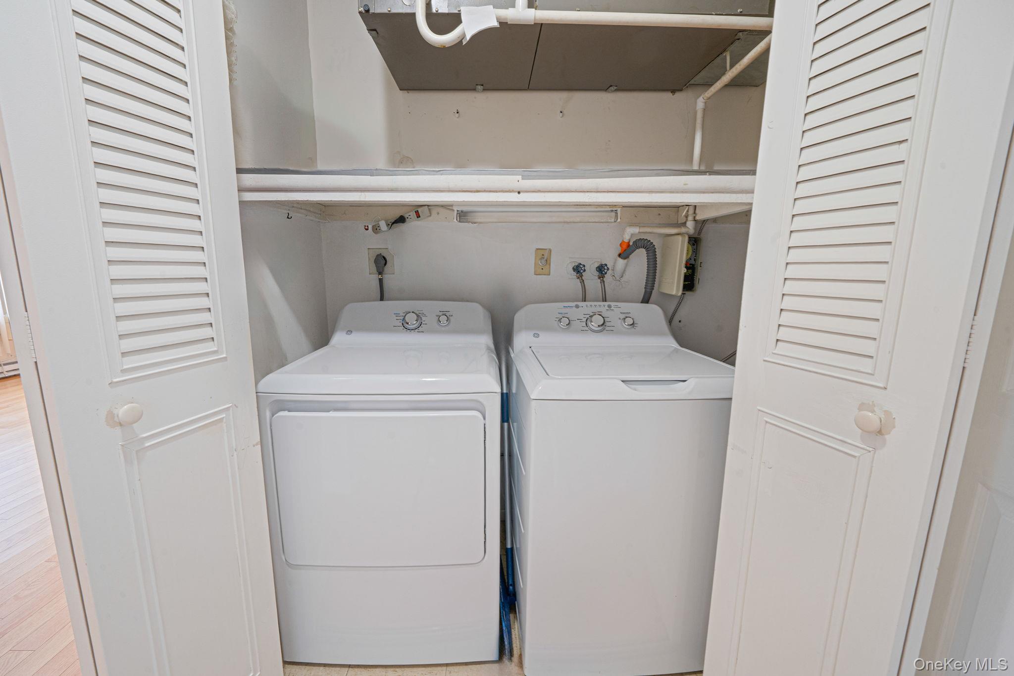 61 Enfield Court, Unit B Ridge, NY 11961 - Photo 30 of 32 a utility room with dryer and washer