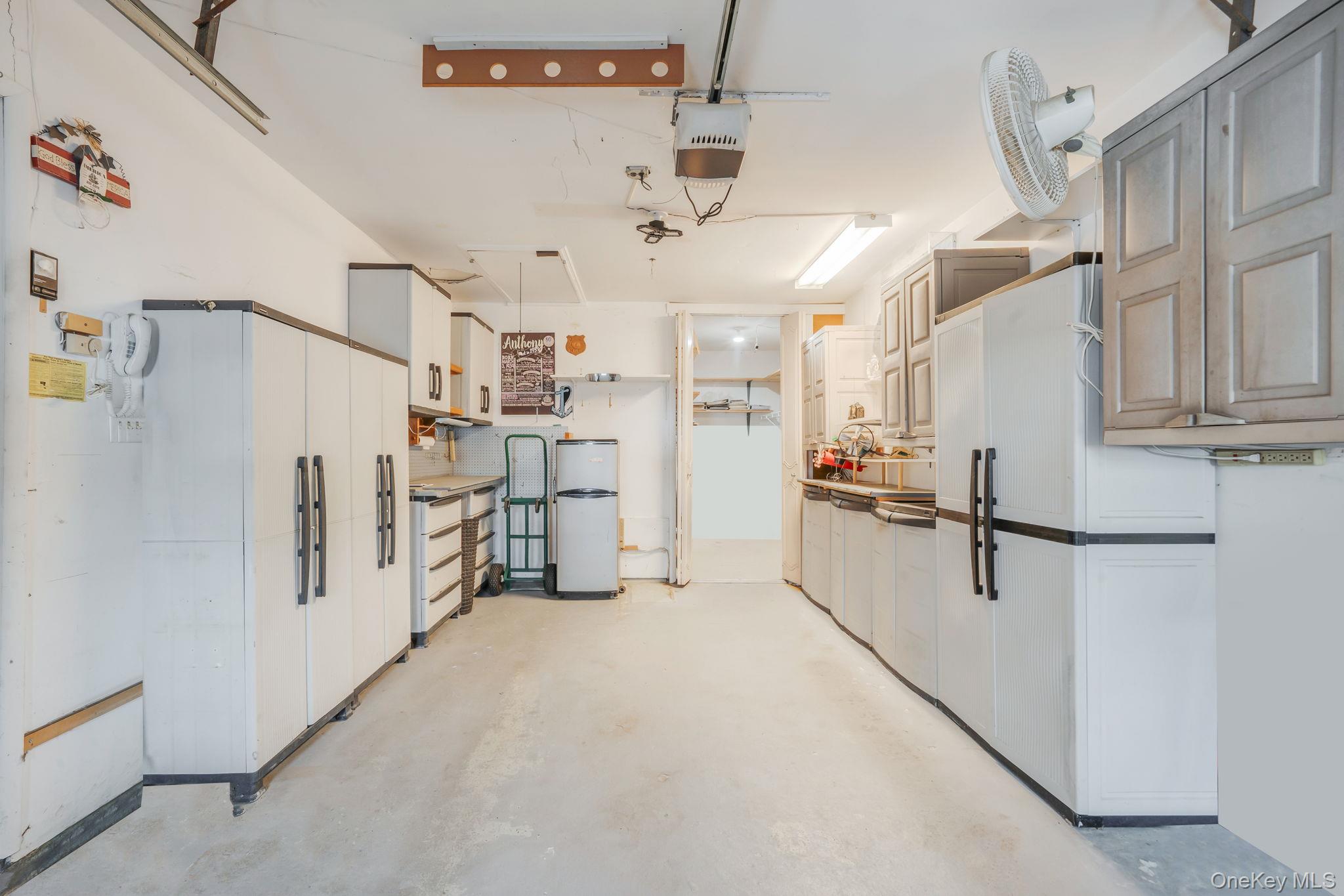 61 Enfield Court, Unit B Ridge, NY 11961 - Photo 31 of 32 a kitchen with refrigerator and cabinets