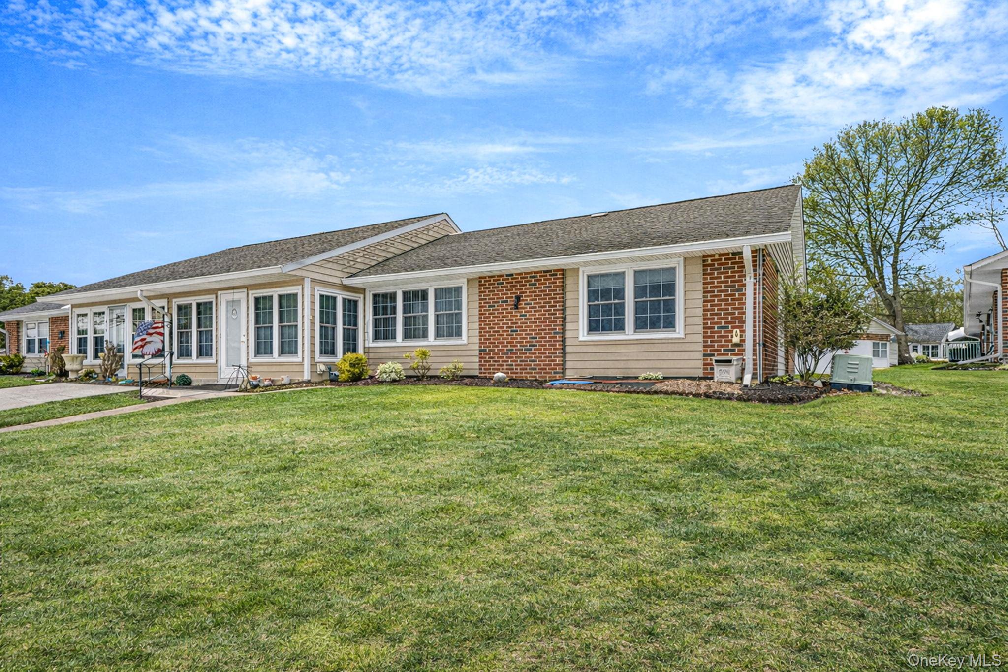61 Enfield Court, Unit B Ridge, NY 11961 - Photo 5 of 32 a view of a house with a backyard