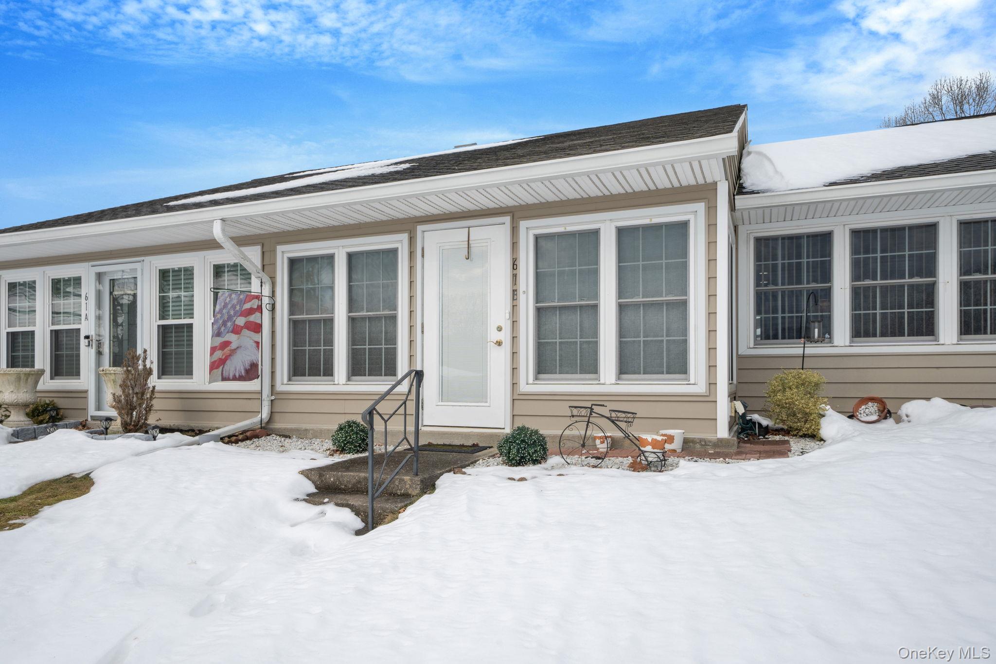 61 Enfield Court, Unit B Ridge, NY 11961 - Photo 6 of 32 front view of a building with a outdoor space