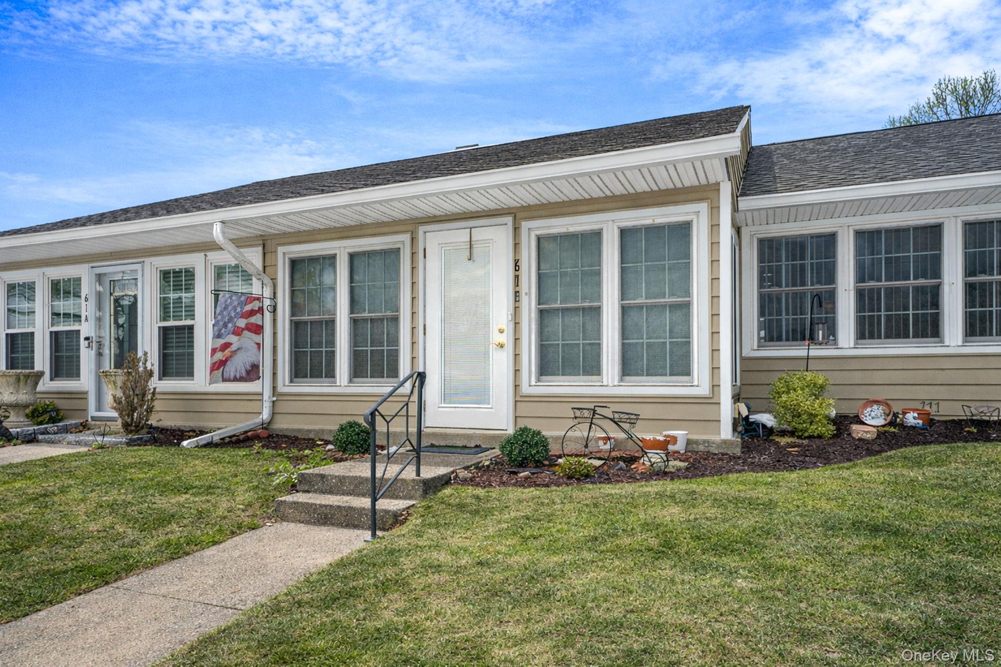 61 Enfield Court, Unit B Ridge, NY 11961 - Photo 7 of 32 front view of a house with a yard