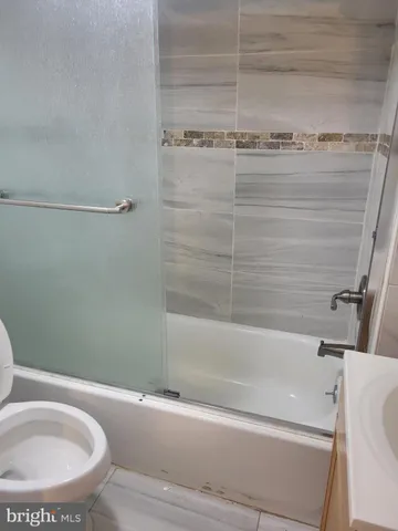 a bathroom with a bathtub and a toilet