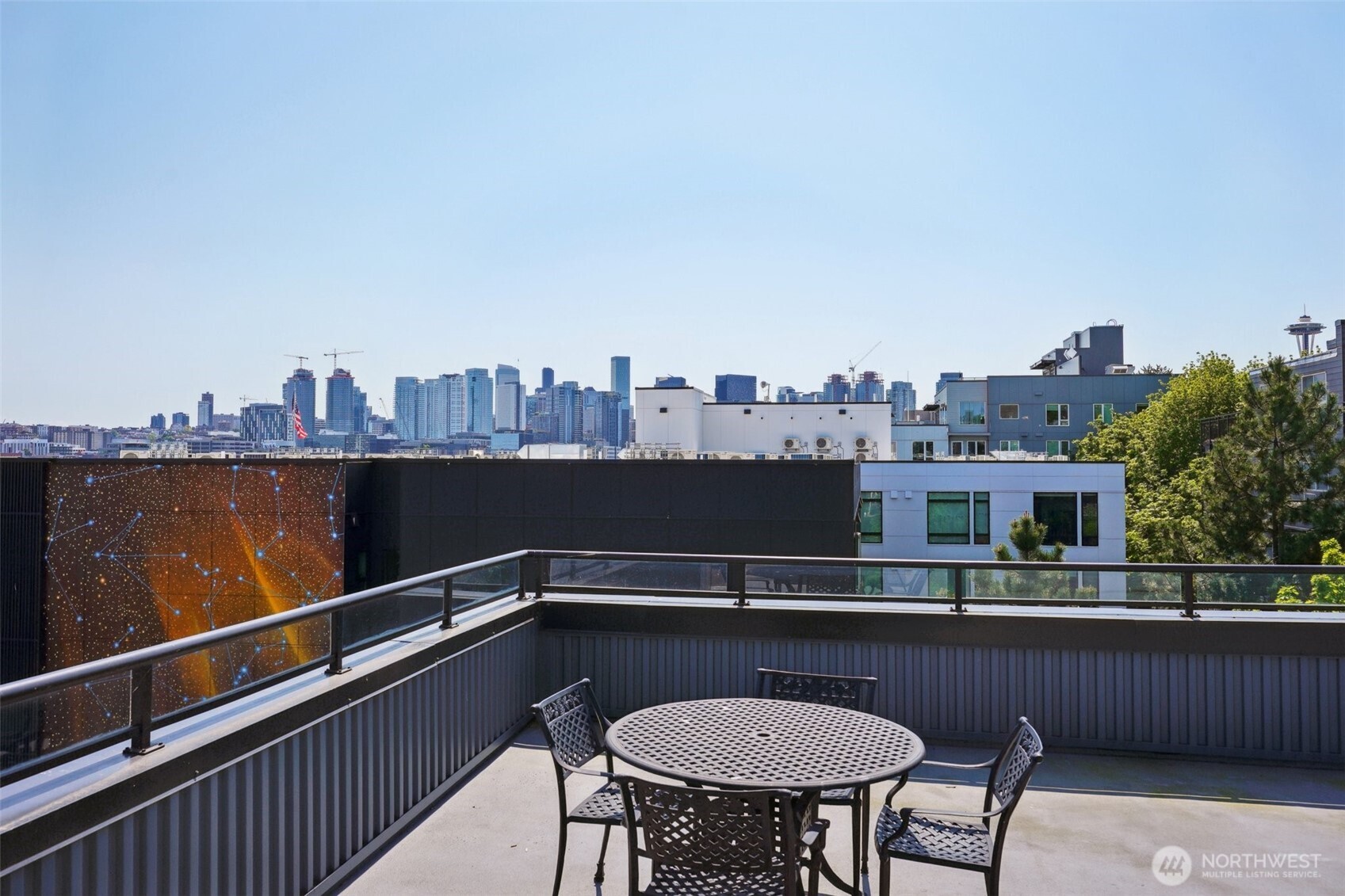 701 Galer Street, Unit 504 Seattle, WA 98109 - Photo 19 of 28 a view of a balcony with a table and chairs