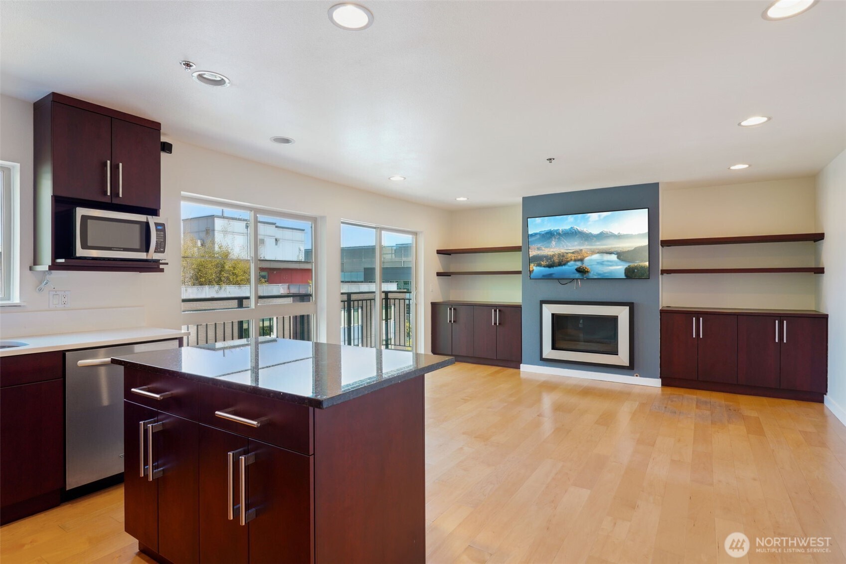 701 Galer Street, Unit 504 Seattle, WA 98109 - Photo 10 of 28 a kitchen with stainless steel appliances granite countertop a sink and a microwave