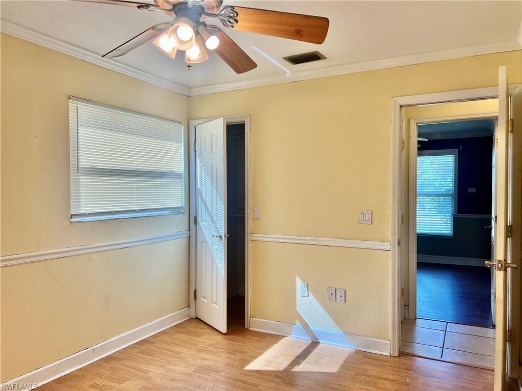 18581 Tampa Road Fort Myers, FL 33967 - Photo 23 of 25 Empty room featuring light hardwood / wood-style flooring, ceiling fan, and crown molding
