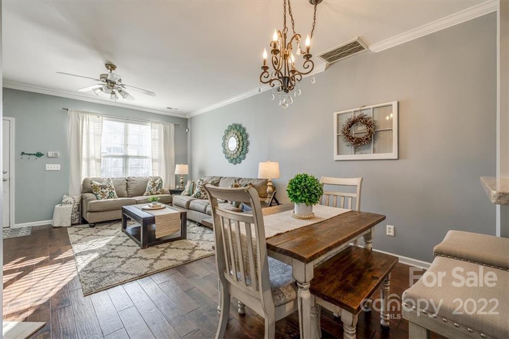 808 Gentlewinds Court Fort Mill, SC 29708 - Photo 8 of 24 a living room with furniture a chandelier and a window