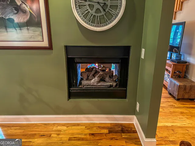 a living room with furniture fireplace and a chandelier