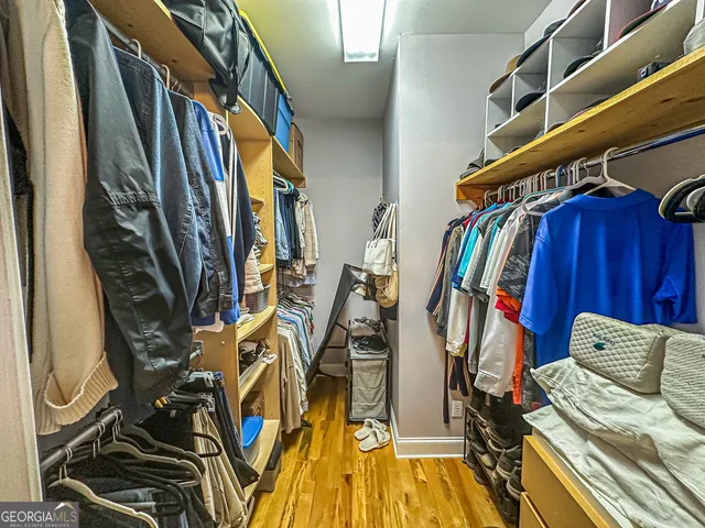 a bedroom with a bed and mirror with window