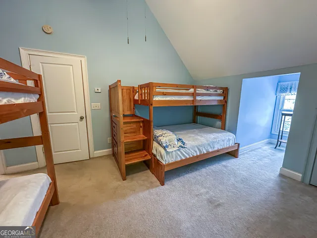 a bedroom with bed and wooden floor