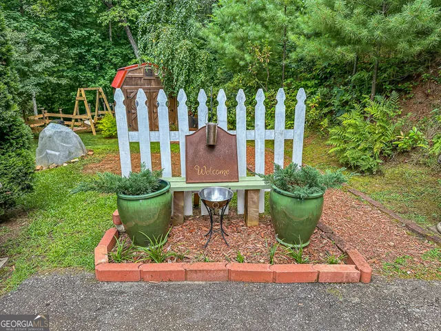 a front view of a house with porch and garden