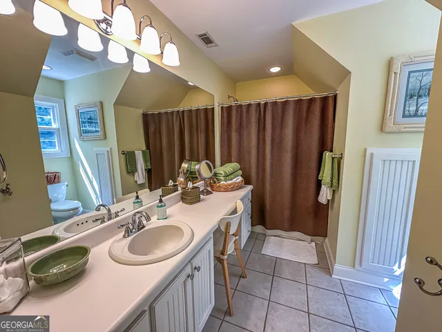a kitchen with stainless steel appliances a stove a sink and a window