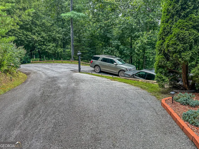 a kitchen with stainless steel appliances granite countertop a stove top oven a dining table and chairs with wooden floor