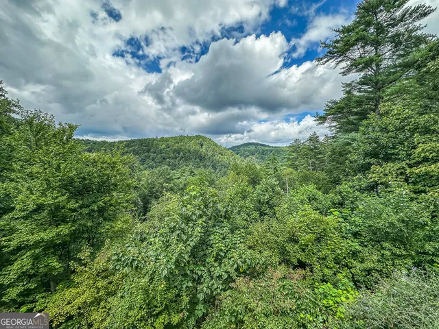 a kitchen with stainless steel appliances granite countertop a stove a sink dishwasher and a refrigerator with wooden floor