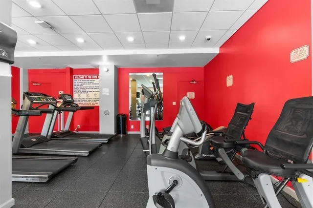 a room with gym equipment and air hockey table