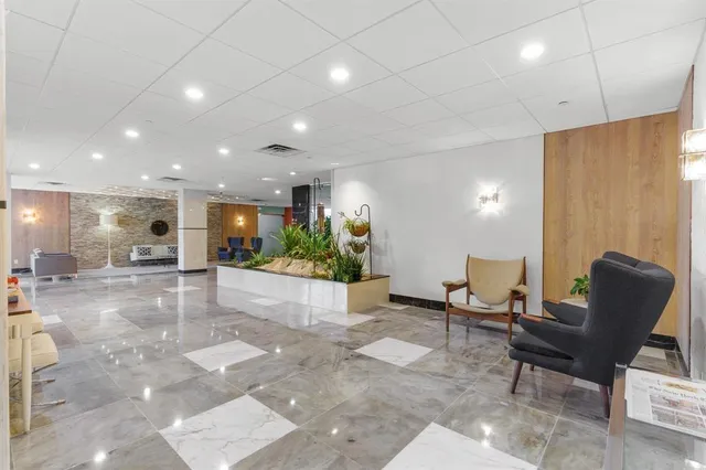 a view of a lobby with furniture and a potted plant