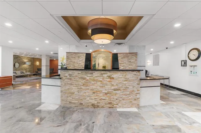 a large kitchen with stainless steel appliances kitchen island granite countertop a sink and cabinets