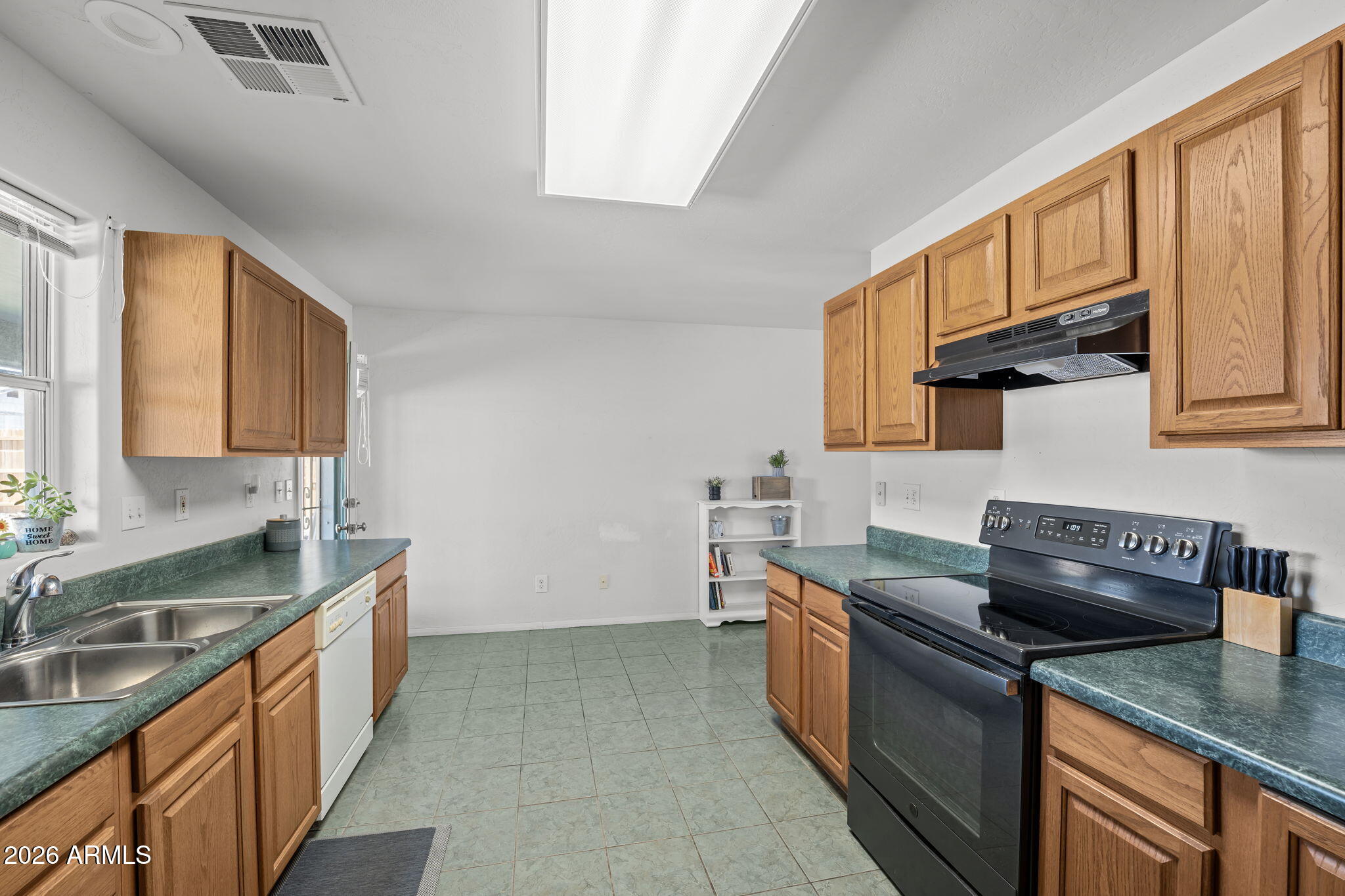 27144 Bennett Way Congress, AZ 85332 - Photo 18 of 33 a kitchen with stainless steel appliances granite countertop a sink stove and cabinets