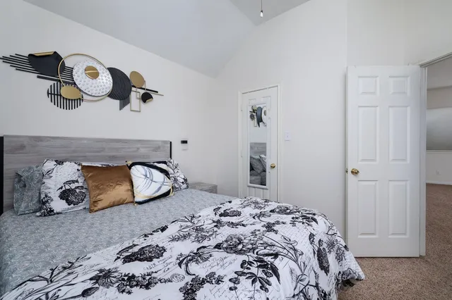 a bedroom with a bed and cabinets