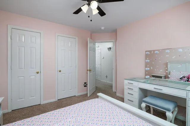 a spacious bedroom with a bed and a chandelier