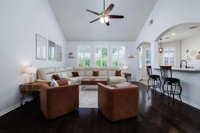 a living room with furniture wooden floor and a window
