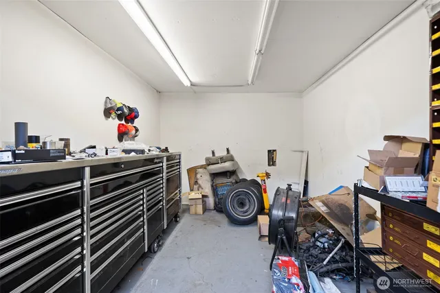 a white house covered with tall trees