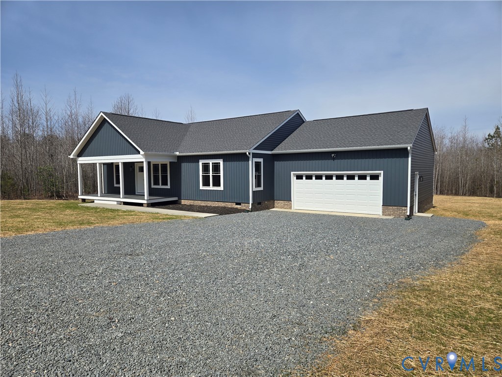 1781 Bumpass Road Bumpass, VA 23024 - Photo 2 of 26 a front view of a house with a yard and garage