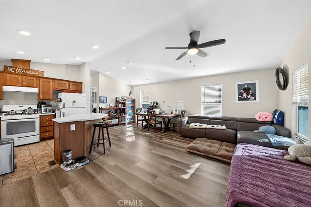 a living room with furniture and kitchen view