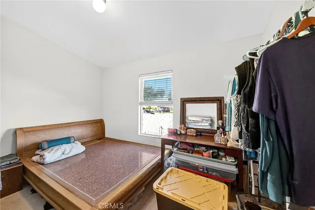 a living room with furniture flat screen tv and a window