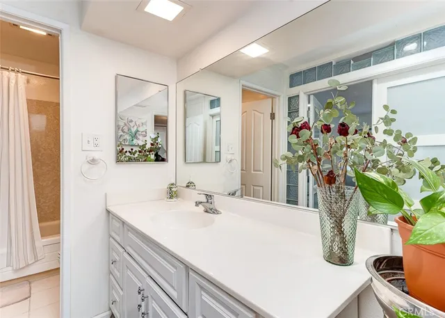 a bathroom with a sink a vanity and a mirror