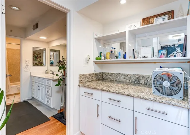 a view of cabinets a sink and a wooden floor