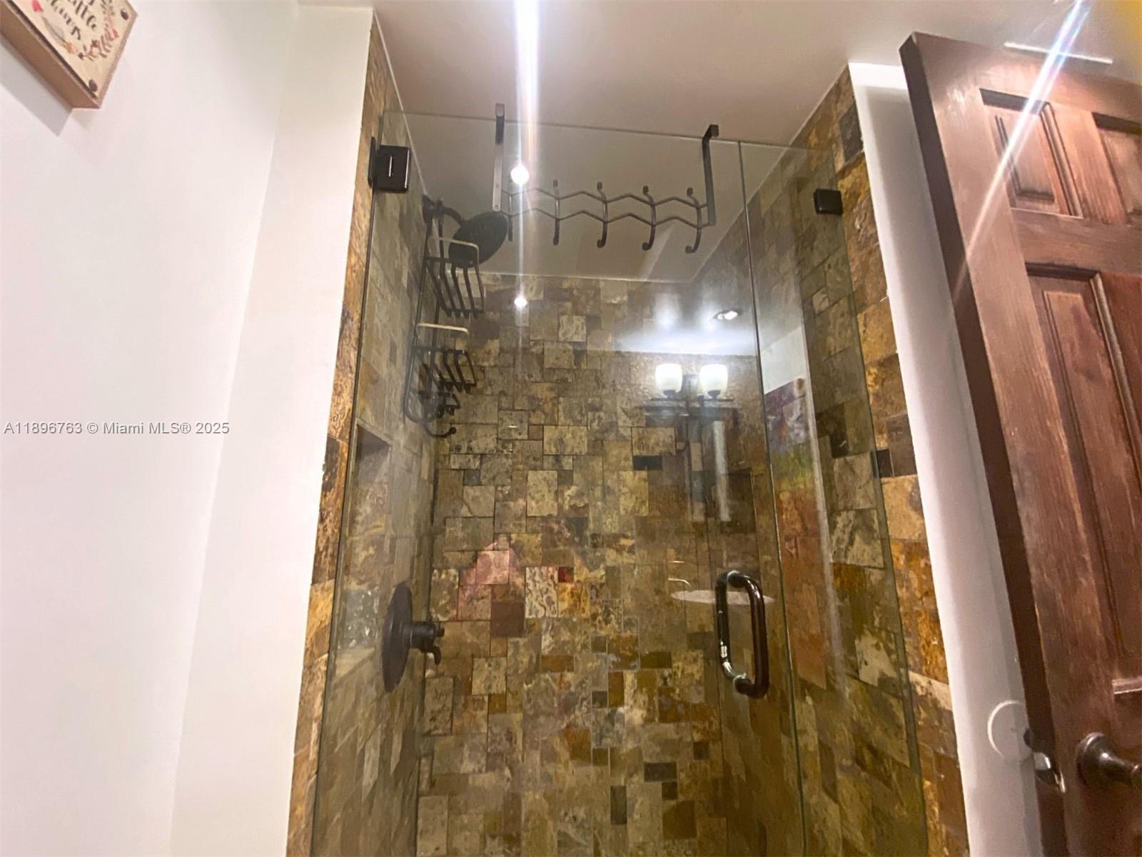 753 Michigan Avenue, Unit 2B Miami Beach, FL 33139 - Photo 12 of 22 a bathroom with a shower