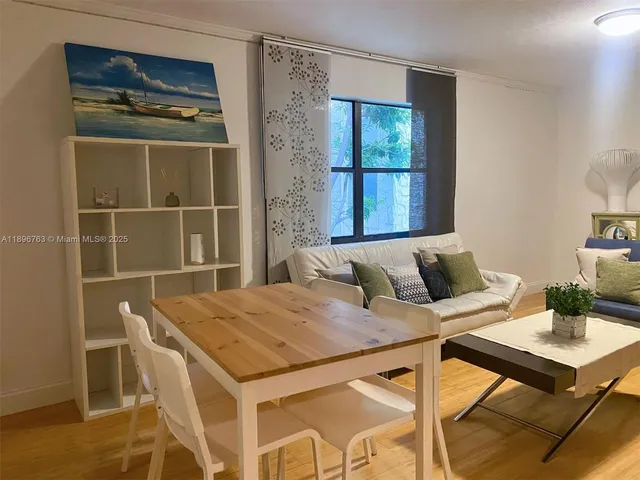 a view of a dining room with furniture and window