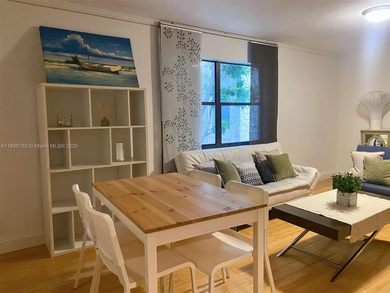 753 Michigan Avenue, Unit 2B Miami Beach, FL 33139 - Photo 5 of 22 a view of a dining room with furniture and window