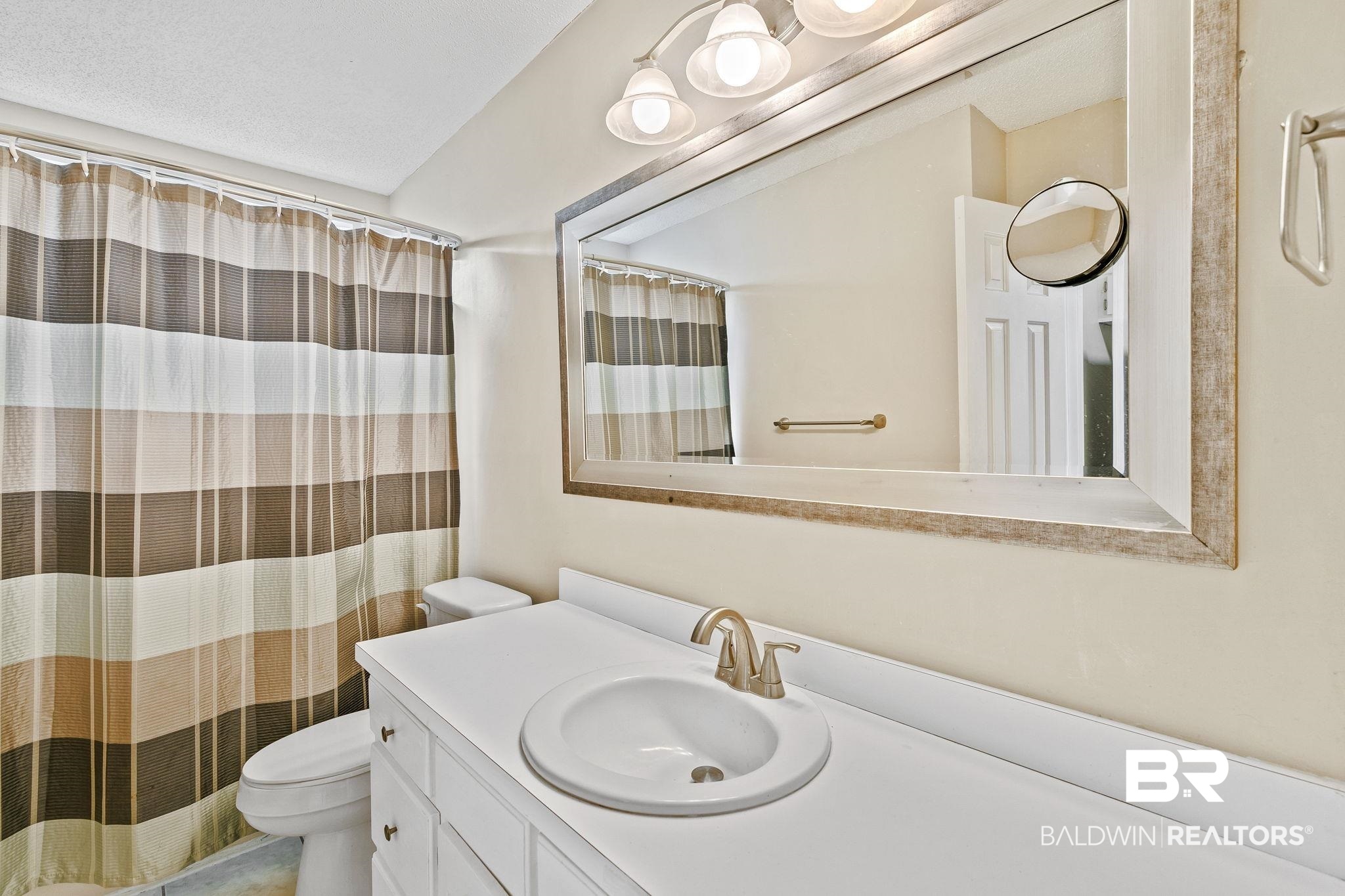 359 Ridgewood Drive Daphne, AL 36526 - Photo 26 of 73 Bathroom featuring vanity, a shower with shower curtain, and toilet