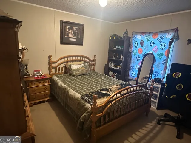 a bedroom with a bed and a table in it