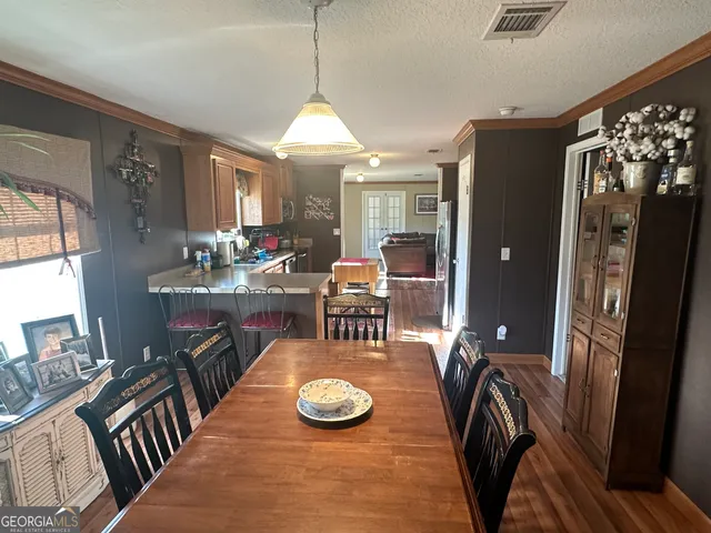 a view of a dining room with furniture window and wooden floor