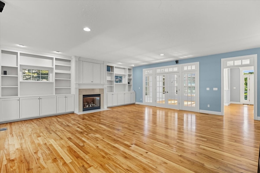 118 Bates Way Hanover, MA 02339 - Photo 17 of 42 a view of an empty room with wooden floor and a window
