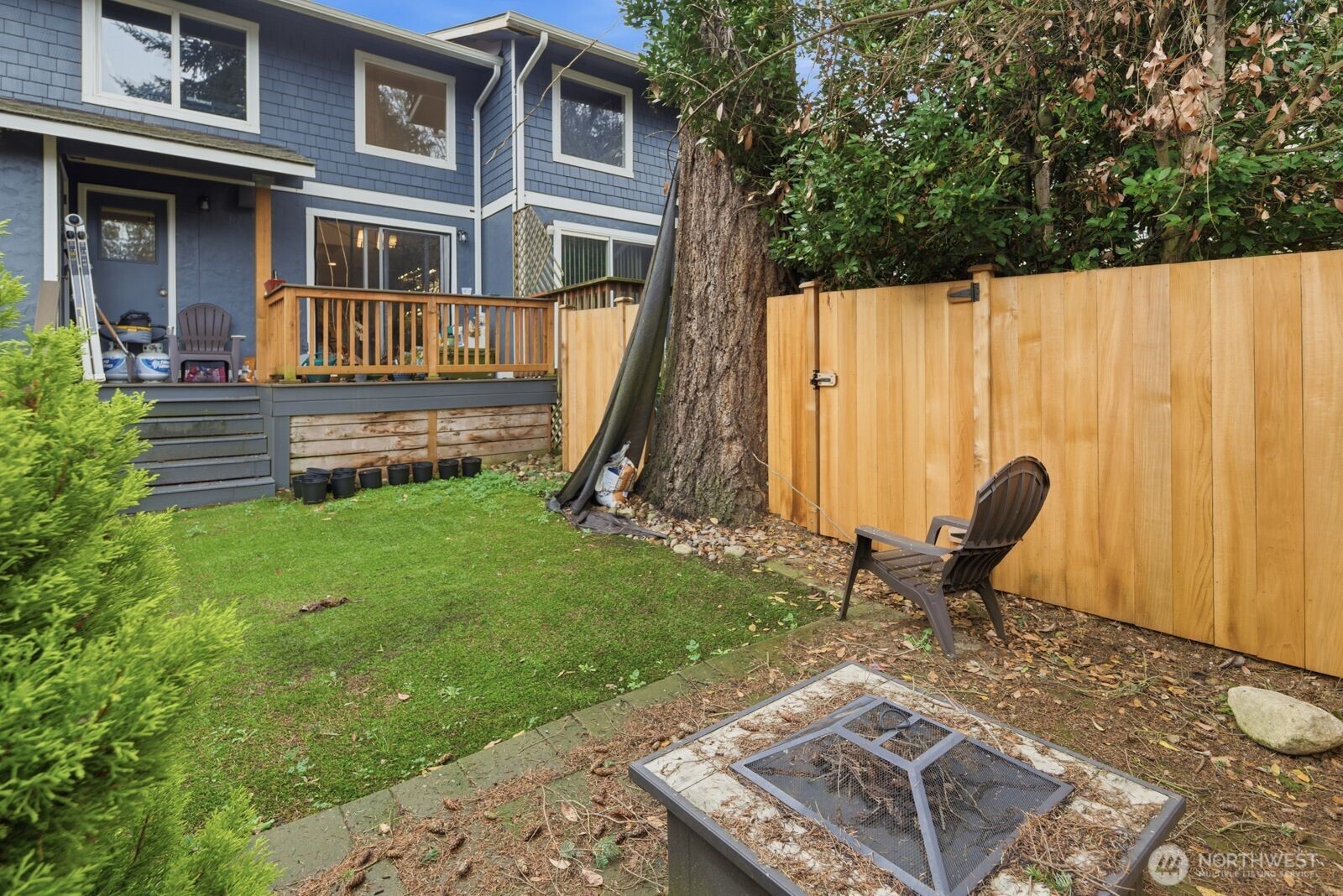 7431 212th Street Southwest, Unit 16 Edmonds, WA 98026 - Photo 15 of 22 a backyard of a house with table and chairs