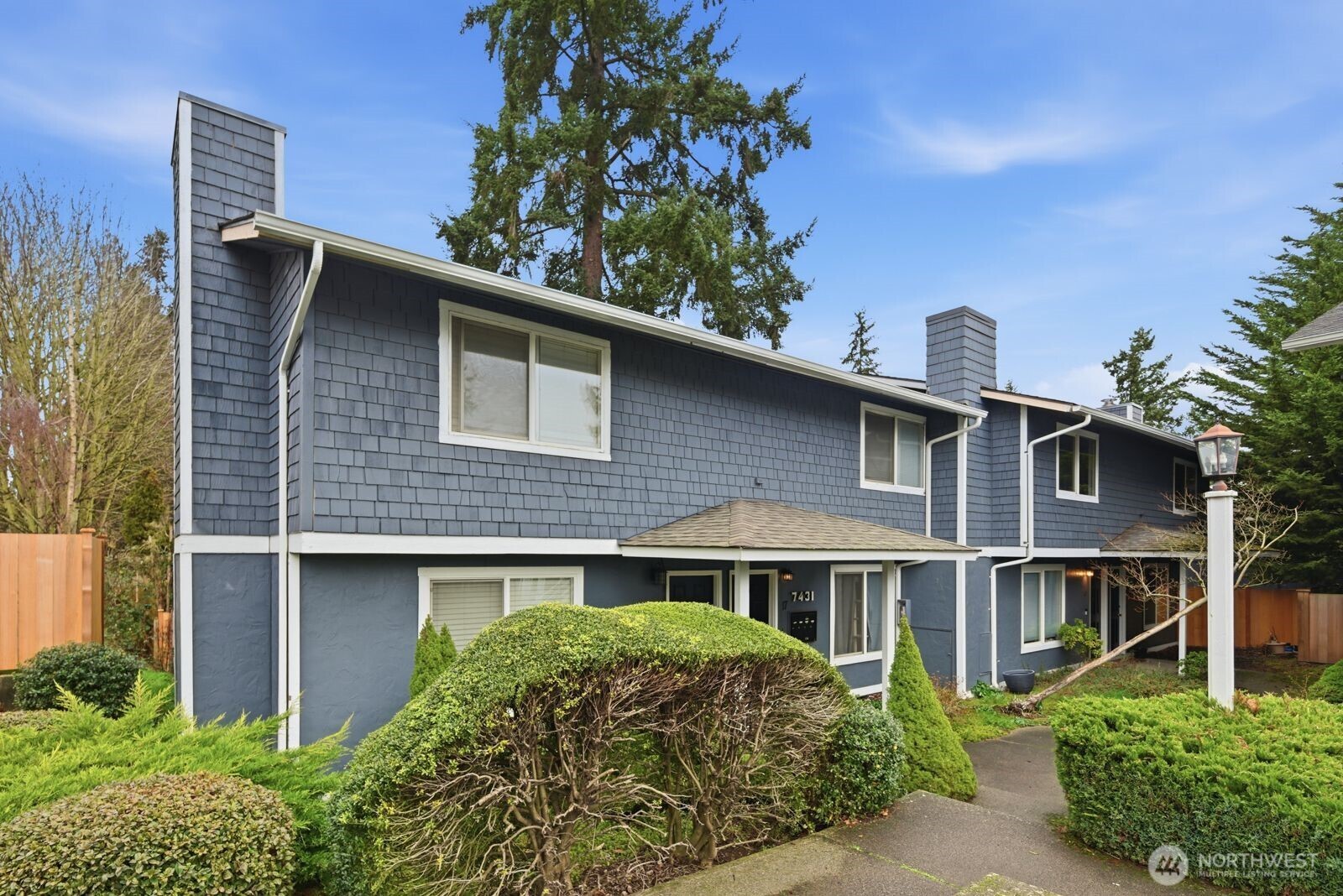 7431 212th Street Southwest, Unit 16 Edmonds, WA 98026 - Photo 6 of 22 a front view of a house with a garden