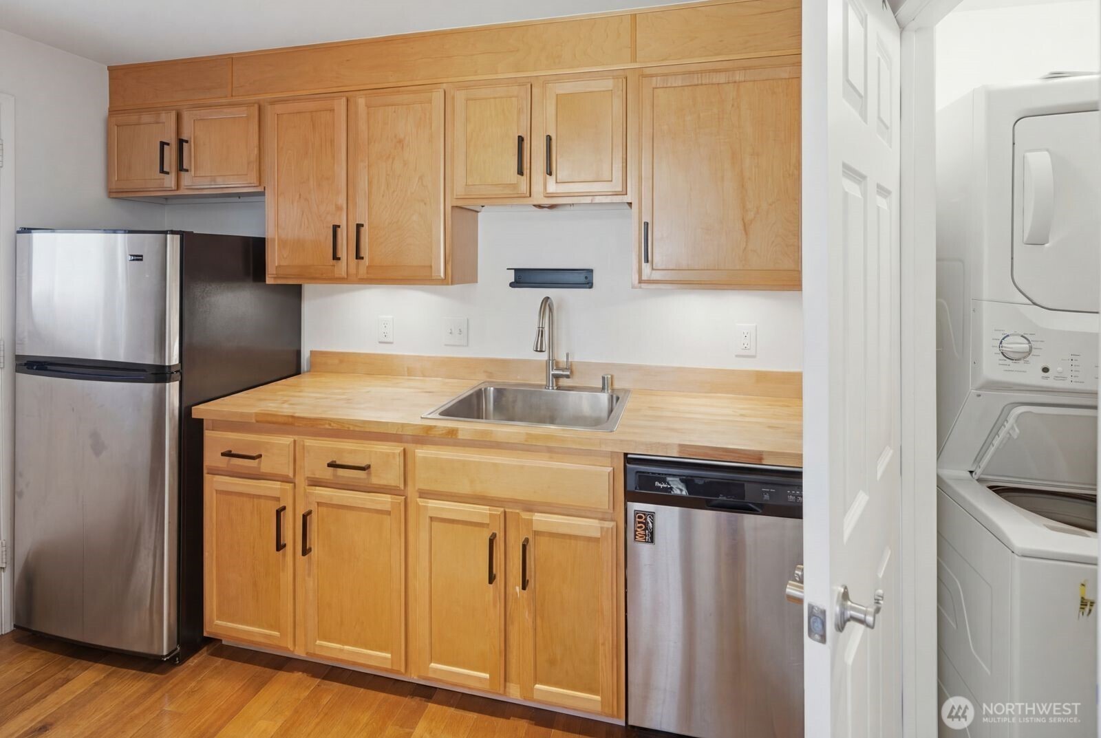 7431 212th Street Southwest, Unit 16 Edmonds, WA 98026 - Photo 8 of 22 a kitchen with stainless steel appliances granite countertop a refrigerator sink and white cabinets